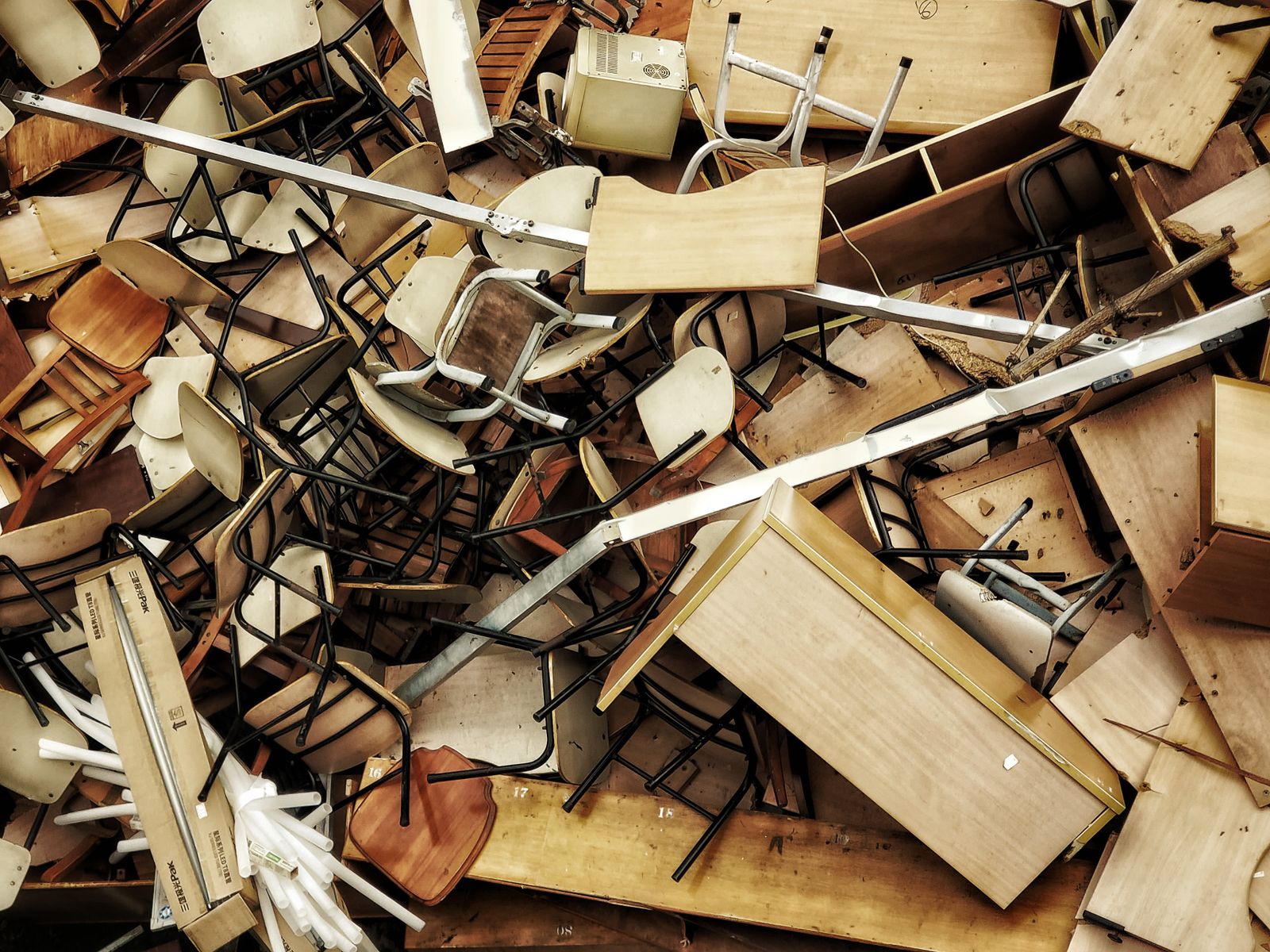 A pile of broken wooden chairs and tables